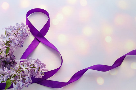 International Women's Day. 8 March. Greeting Card. Decoration with Purple Ribbon and Lilac on a white background with bokeh.