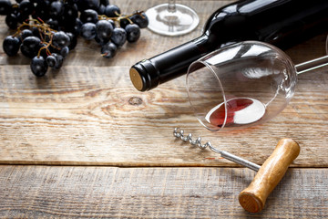 Fototapeta na wymiar restaurant set with wine bottle and grape on wooden background