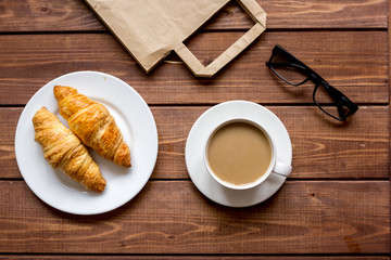 Business breakfast with coffee and croussant top view