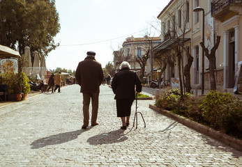 Mature couple walking in a street of Athens