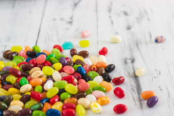 Candy jelly beans on bright wooden background