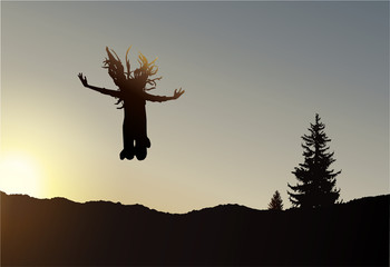 Silhouette of jumping girl with long hair on the wilderness. Sunset.