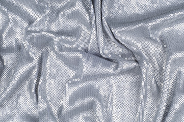 Silk fabric texture, background. Covered with sequins, silver color