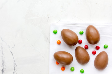 Easter chocolate eggs top view on stone background mock up