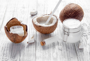 organic cosmetics with coconut on wooden background close up