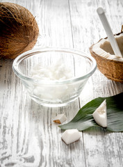organic cosmetics with coconut on wooden background close up