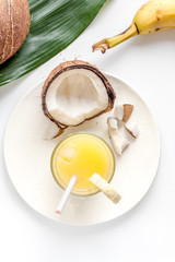 cocktail with coconut on white background top view