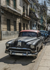 Vintage classic american car parked in a street of Old Havana,Cuba.
