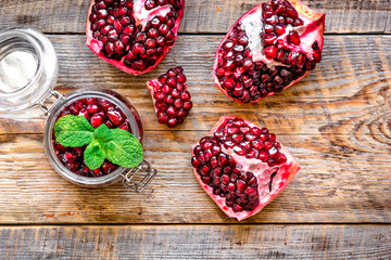 sliced pomegranate on wooden background top view