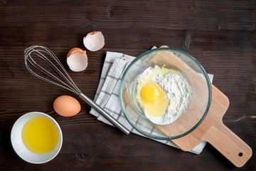 cooking pancake on wooden background top view ingredients for making