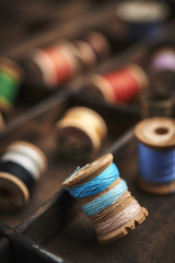 vintage spools of thread on a distressed wood surface