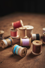 vintage spools of thread on a distressed wood surface