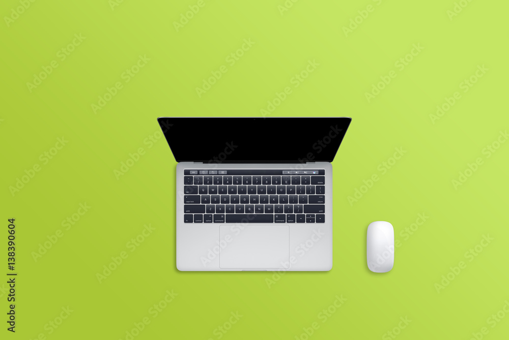 Aufkleber Laptop computer and mouse on green desk. Free space for text. Blank display for mockup.