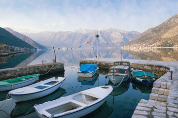 Fishing boats in the small harbor near seaside Stoliv village. Bay of Kotor, Montenegro, winter