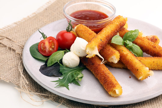 Breaded mozzarella cheese sticks with tomato ketchup and bbq sauce