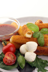 Breaded mozzarella cheese sticks with tomato ketchup and bbq sauce