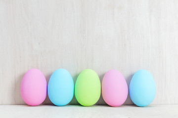 Fototapeta na wymiar Pastel Easter eggs on wooden table.