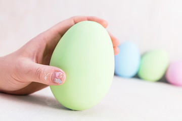 Hand holding one Easter Egg.