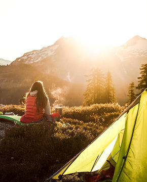 Woman looking at snow capped mountains at sunrise, Elfin Lakes, Canada, British Columbia, North America 