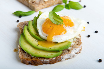 Sandwich with avocado slices and basil