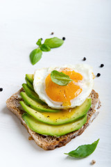 Sandwich with avocado slices and basil