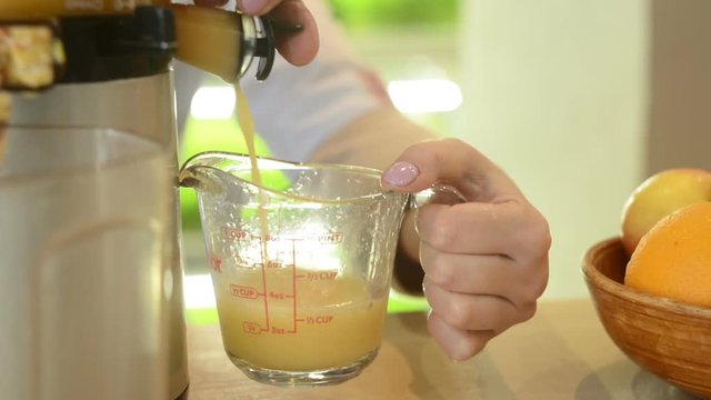 healthy eating - the taking of fresh apple juice with a juicer, close-up