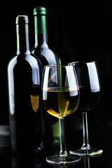 Wine glass and Bottle on black background. Red and white wine