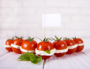 Sliced cherry tomato and mozzarella with basil leafs. Burger style