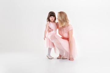 blonde mom and sweet little daughter in pink dresses princesses 
