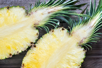 Pineapple on the wooden background: cross section