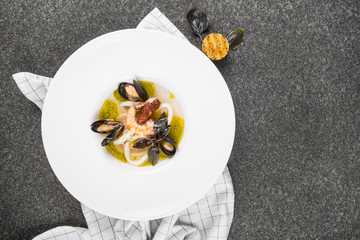 Delicious mediterranean seafood soup. Tasty fish soup with cod, shrimp, mussels and other molluscs. Spicy french soup bouillabaisse with seafood. Traditional in France and Spain. Top view. flat lay