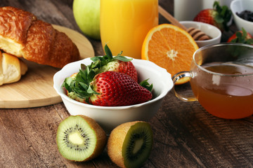 breakfast on table with waffles, croissants, coffe and juice