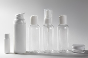 Fototapeta na wymiar White cosmetic bottles on white background. Wellness, spa and body care bottles collection. Beauty treatment