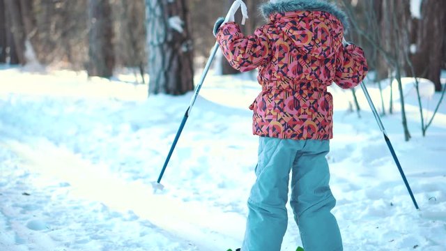 A little girl is learning cross country skiing