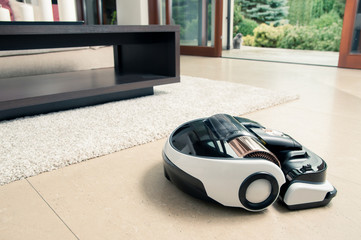Robot vacuum cleaner working in modern home