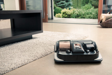 Robot vacuum cleaner working in modern home