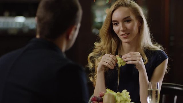 romantic pair drinking champagne in restaurant
