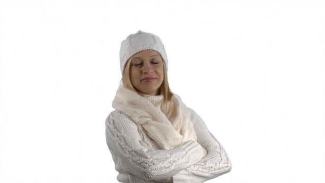 Pregnant woman wearing a white woolen sweater scarf knitted cap and gloves posing on white background. 4k footage PNG with alpha channel