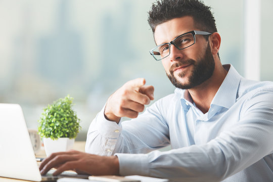 Man using laptop and pointing