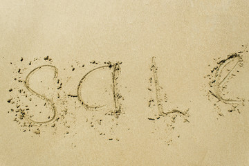 Inscription SALE on sand.