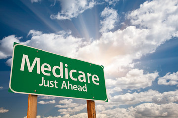 Medicare Green Road Sign Over Dramatic Clouds and Sky. - obrazy, fototapety, plakaty