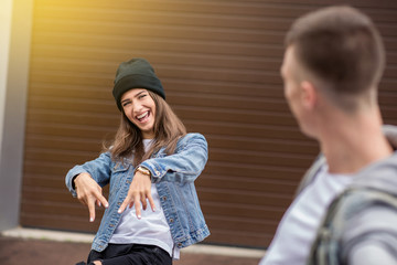 Swag woman looks on man in denim wear, crazy couple in love