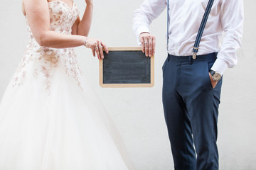 married couple holding a blackboard celebrating wedding marriage