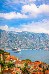 Fototapeta na wymiar Beautiful mediterranean landscape. Cruise ship near town Perast, Kotor bay (Boka Kotorska), Montenegro.