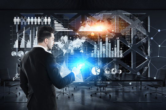 Rear view of businessman, smartphone, graphs