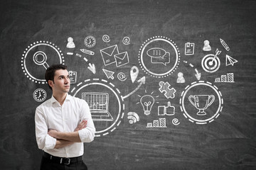 Pensive businessman and business prize, blackboard