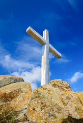 Wooden cross standing on a rock