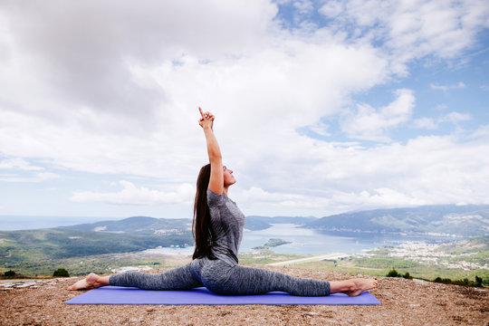 woman practicing yoga in mountains