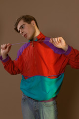 Cute guy in hipster clothes 90s posing in studio