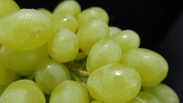 Camera slides over a bunch of grapes